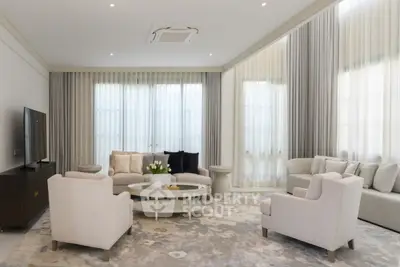 Elegant living room with modern furniture and large windows, perfect for relaxation and entertainment.