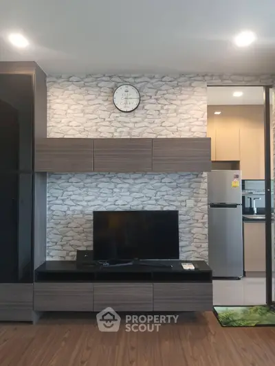 Modern living room with stylish TV unit and kitchen view