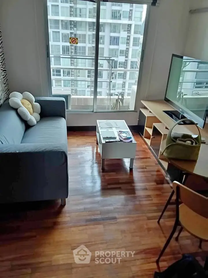 Cozy living room with modern furniture and city view, perfect for urban living.