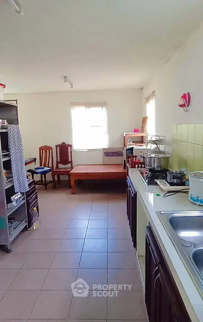Spacious kitchen with ample natural light and modern fixtures, perfect for culinary enthusiasts.