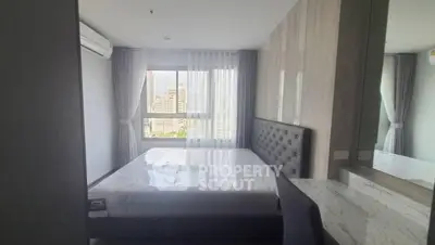 Modern bedroom with city view, featuring a stylish bed and elegant decor, perfect for urban living.