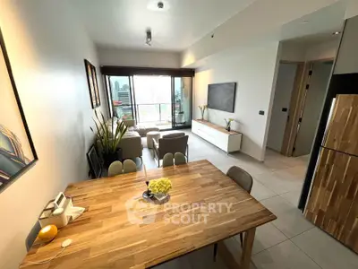 Modern living room with dining area and balcony view in a stylish apartment.