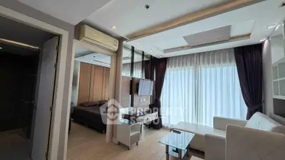 Modern living room with elegant decor and natural light, featuring a cozy bedroom view.