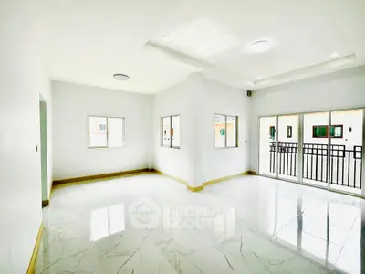 Spacious and bright living room with modern tile flooring and large windows.