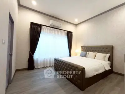 Spacious modern bedroom with elegant decor and natural light