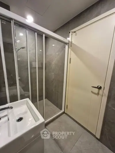 Modern bathroom with sleek shower and elegant sink