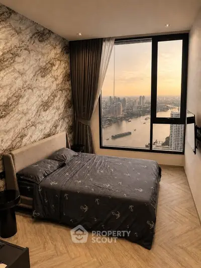 Luxurious bedroom with stunning river view and elegant decor in high-rise apartment.