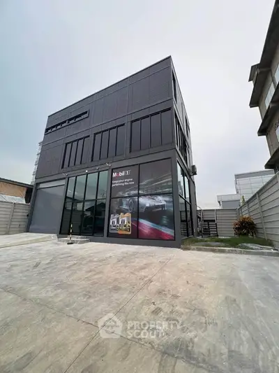 Modern commercial building with sleek design and large windows, ideal for business operations.