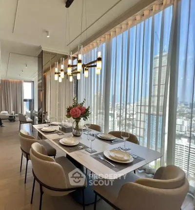 Luxurious dining area with panoramic city views and elegant decor in a high-rise apartment.