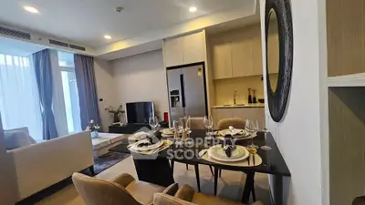 Modern open-plan living and dining area with elegant decor and natural light