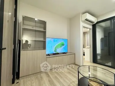 Modern living room with sleek TV setup and glass coffee table