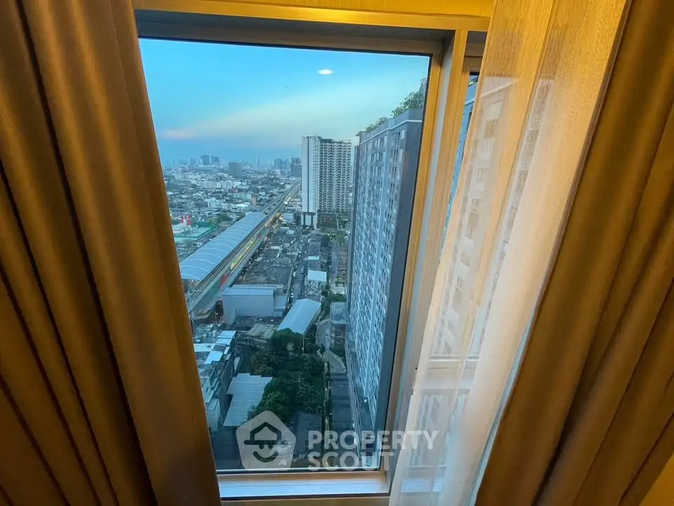 Stunning cityscape view from high-rise apartment window at sunset