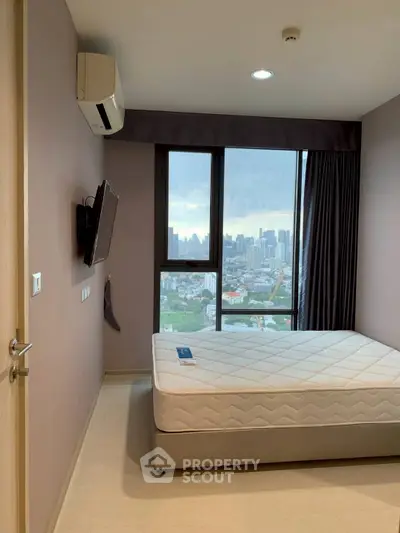 Modern bedroom with city view, featuring a wall-mounted TV and air conditioning.