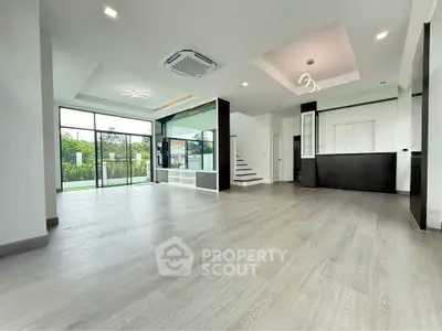 Spacious modern living room with open layout and large windows
