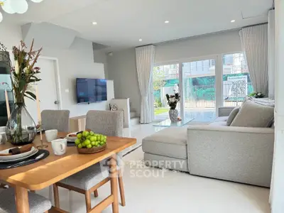 Spacious modern living room with elegant dining area and large windows