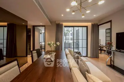 Elegant dining area with modern lighting and balcony view in luxury apartment