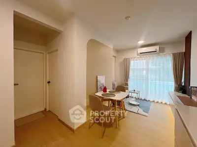 Modern living room with dining area and large window for natural light