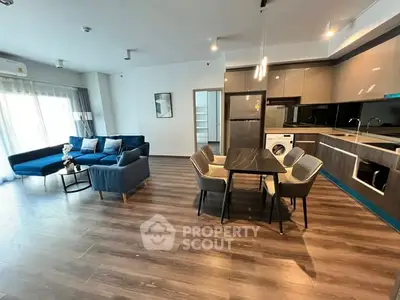 Modern open-plan living room with sleek kitchen and stylish furniture