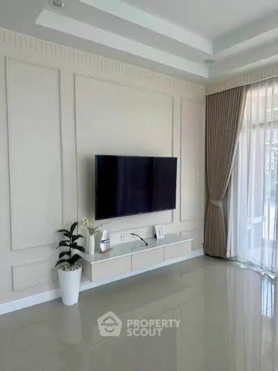Modern living room with wall-mounted TV and elegant decor