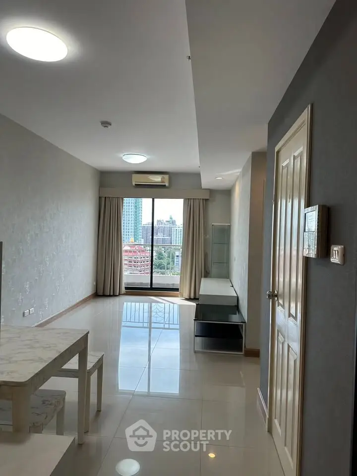 Spacious living room with city view and modern furnishings