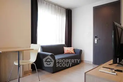 Modern living room with sleek sofa and natural light, perfect for urban living.