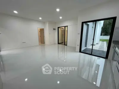 Spacious modern living room with sliding glass doors and glossy floors