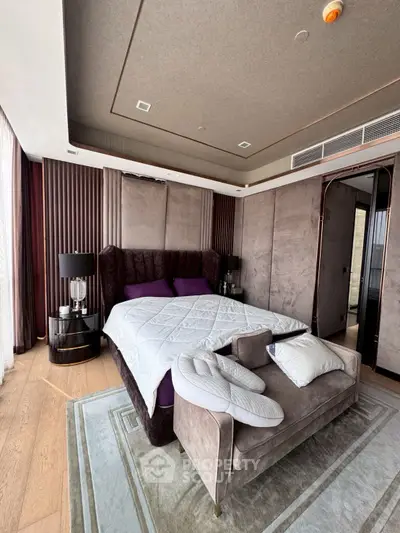 Luxurious bedroom with plush bed, elegant decor, and modern furnishings in a high-end apartment.