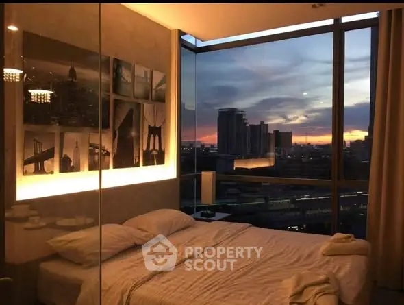 Luxurious bedroom with stunning city view at sunset, featuring modern decor and large windows.