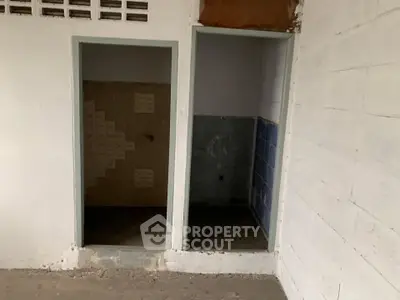 Unfinished interior space with two small tiled areas, potential for customization.