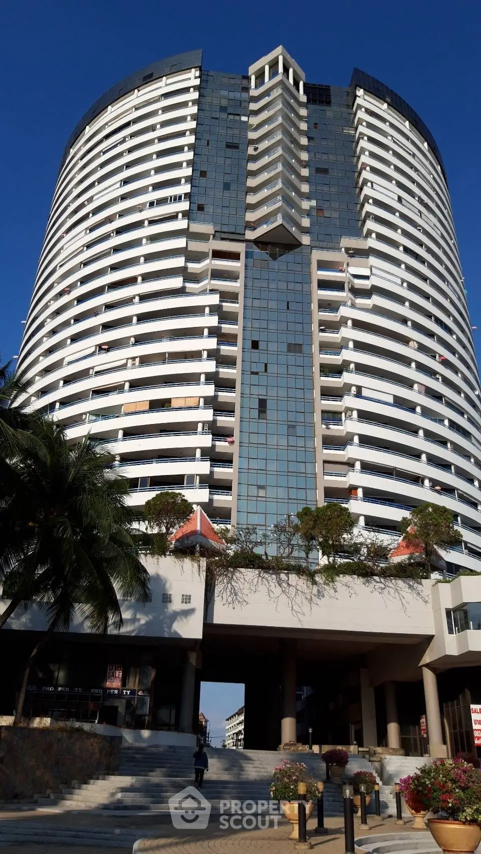 Stunning modern high-rise building with unique architectural design and spacious balconies.