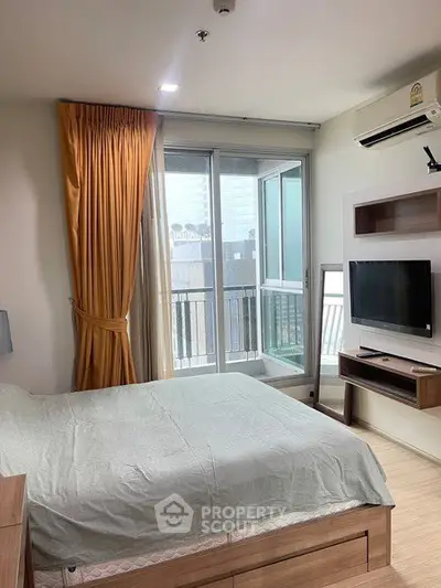 Modern bedroom with balcony access and natural light