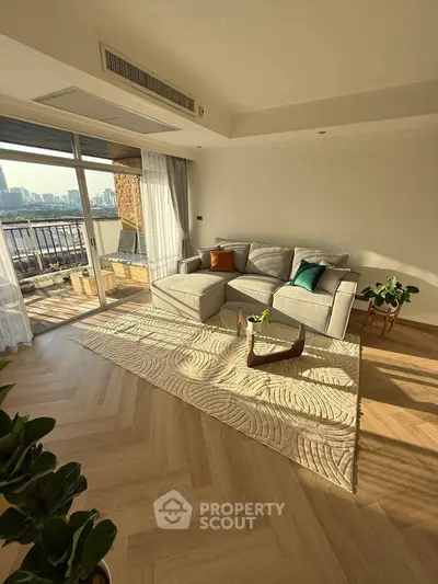 Spacious living room with elegant decor and stunning city view from balcony.