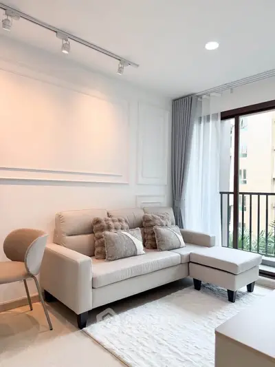 Elegant living room with modern sofa and balcony view