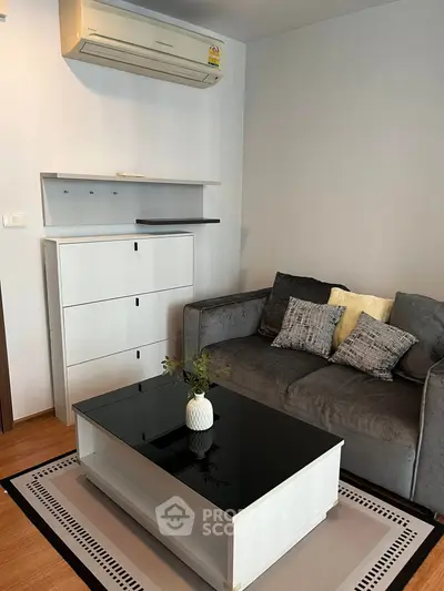 Cozy living room with modern sofa and sleek coffee table, perfect for relaxation.