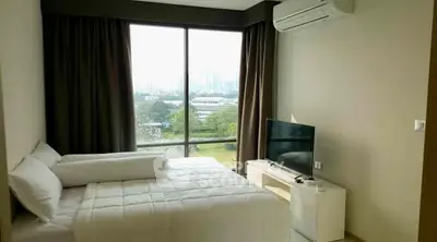 Modern bedroom with large window offering stunning city view and natural light.
