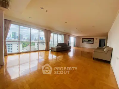 Spacious living room with large windows and city view in modern apartment