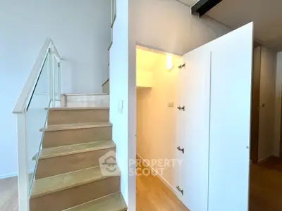 Modern interior with wooden staircase and sleek storage space