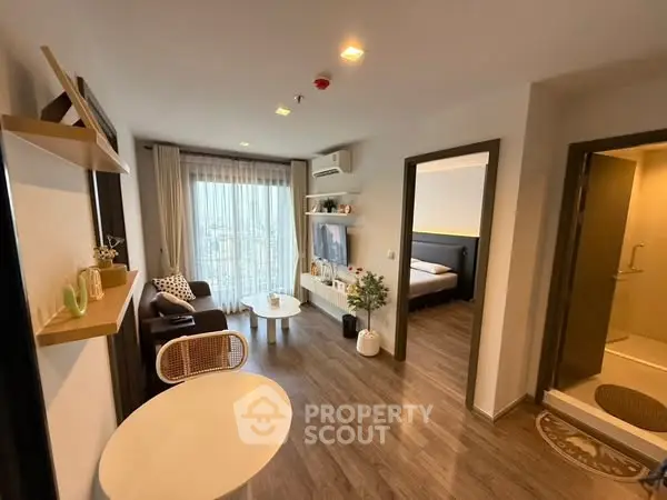 Modern apartment interior with cozy living room and bedroom, featuring stylish decor and natural light.