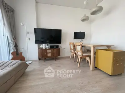 Modern living room with wooden furniture and large TV, perfect for relaxation and entertainment.