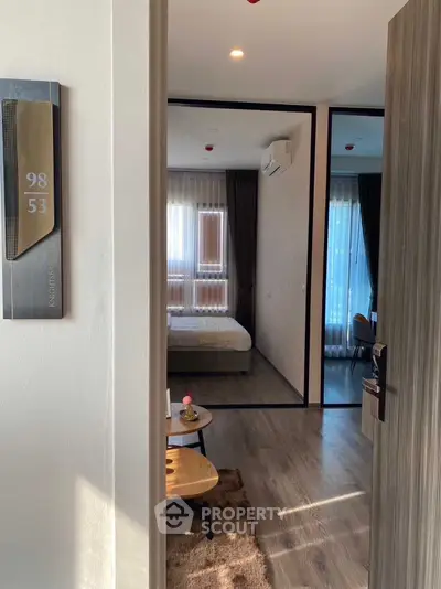 Modern bedroom with stylish decor and natural light, featuring a cozy bed and elegant furnishings.