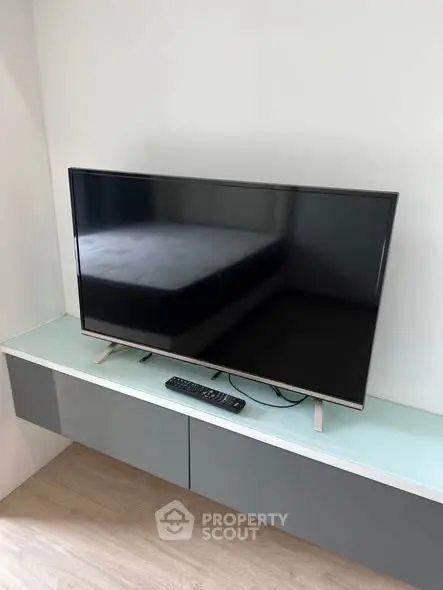 Modern living room with sleek TV on stylish console, perfect for entertainment.