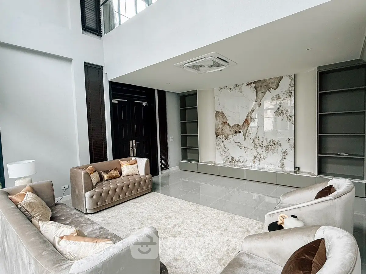 Luxurious modern living room with elegant sofas and marble accent wall