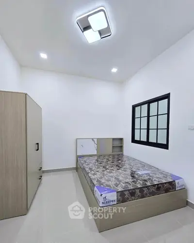 Modern minimalist bedroom with sleek furniture and stylish lighting