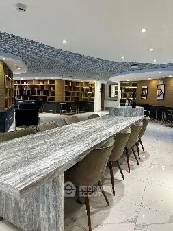 Luxurious modern library with elegant seating and marble table, perfect for sophisticated gatherings.