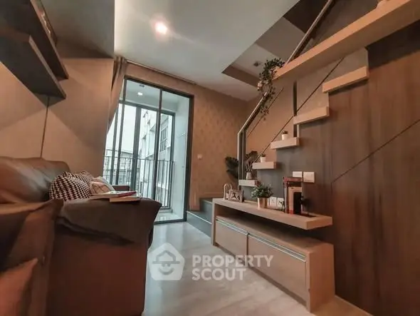 Modern living room with stylish staircase and balcony access