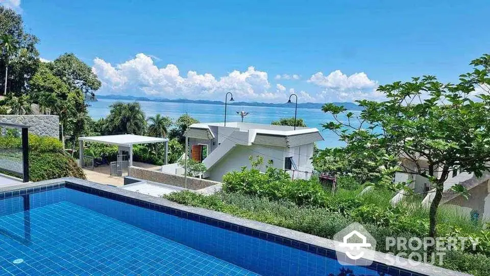 Stunning ocean view from luxury poolside villa with lush greenery