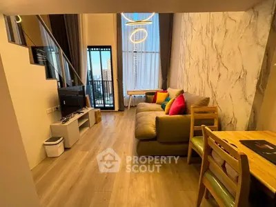 Modern living room with high ceiling and balcony view in stylish apartment