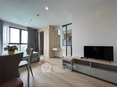 Modern living room with wooden flooring, large windows, and stylish furniture in a high-rise apartment.