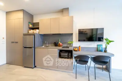 Modern kitchen with sleek cabinetry, integrated appliances, and stylish dining area.