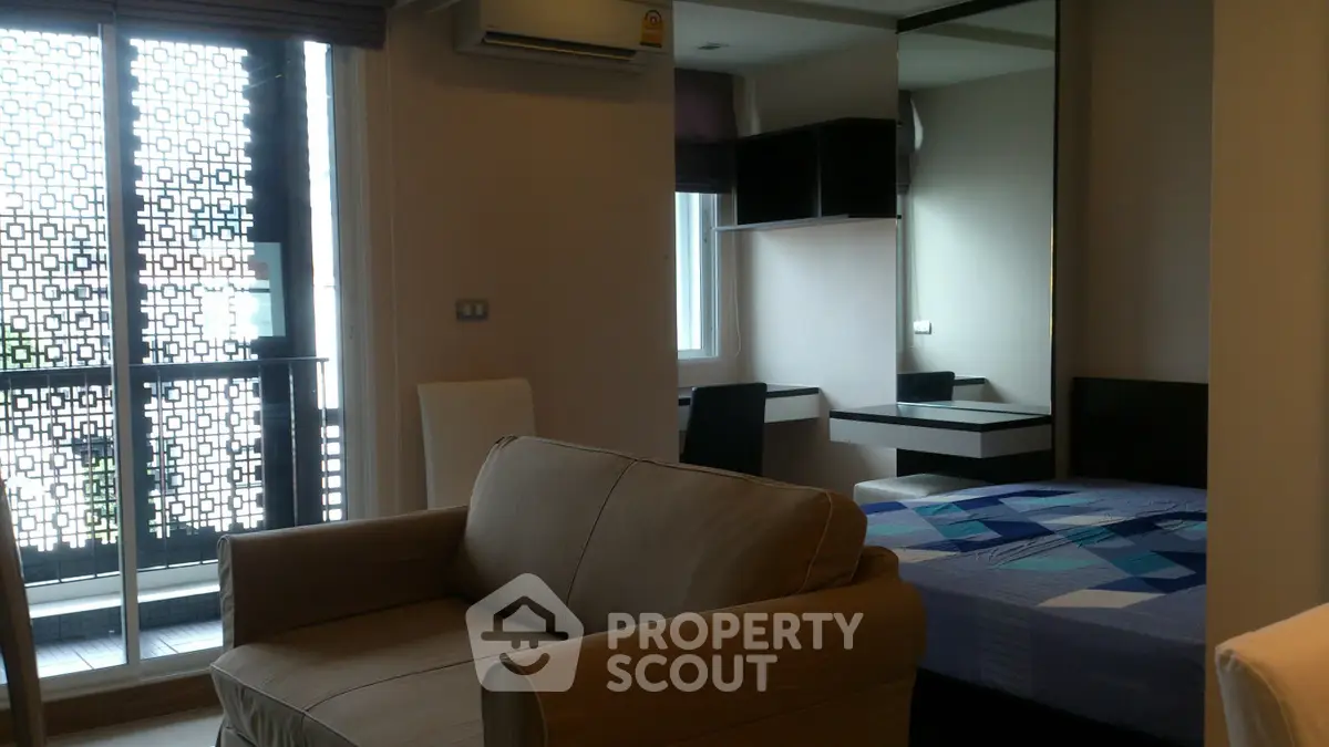 Modern studio apartment with cozy living area and stylish bedroom